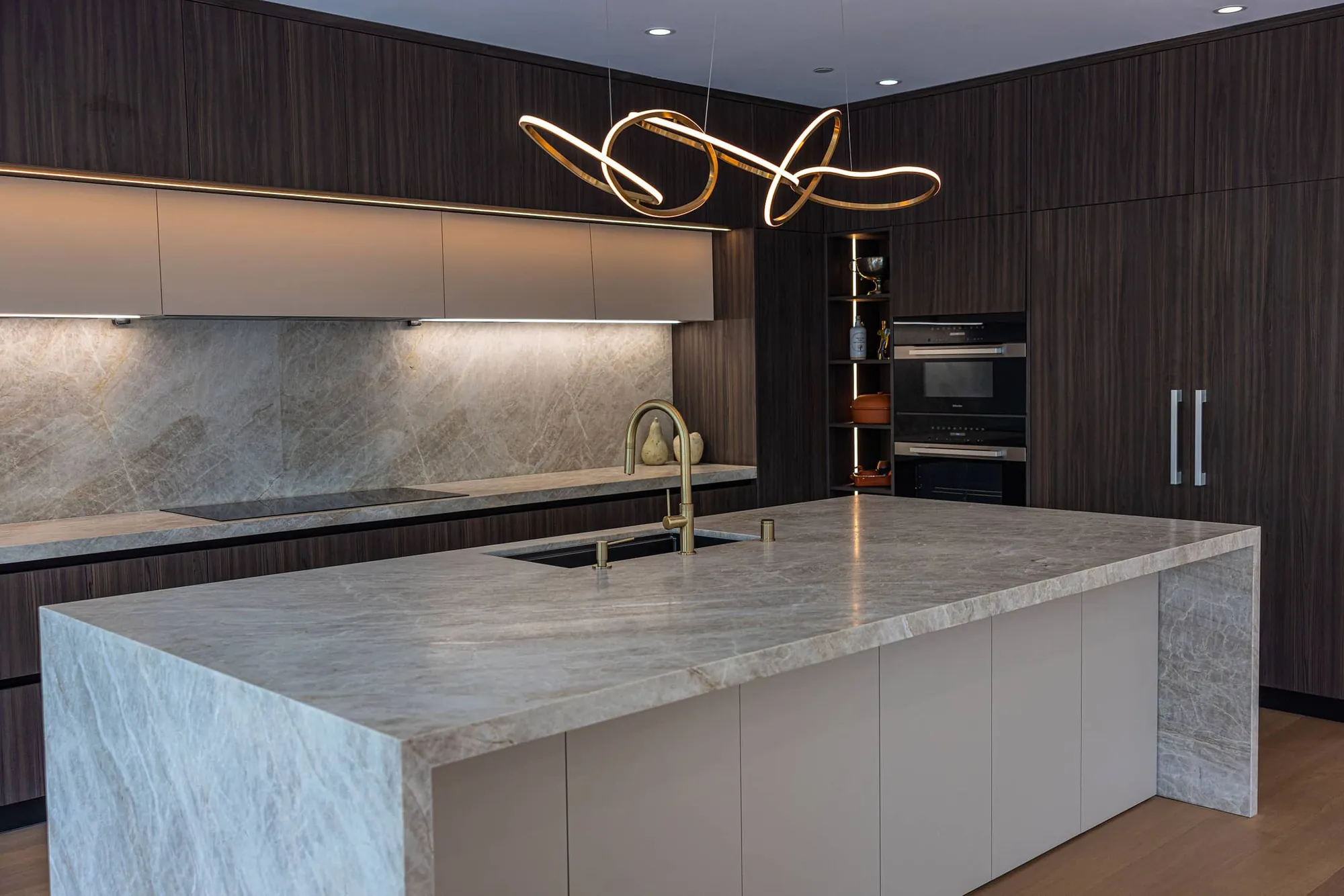 Angled view of the Los Altos kitchen island and modern lighting