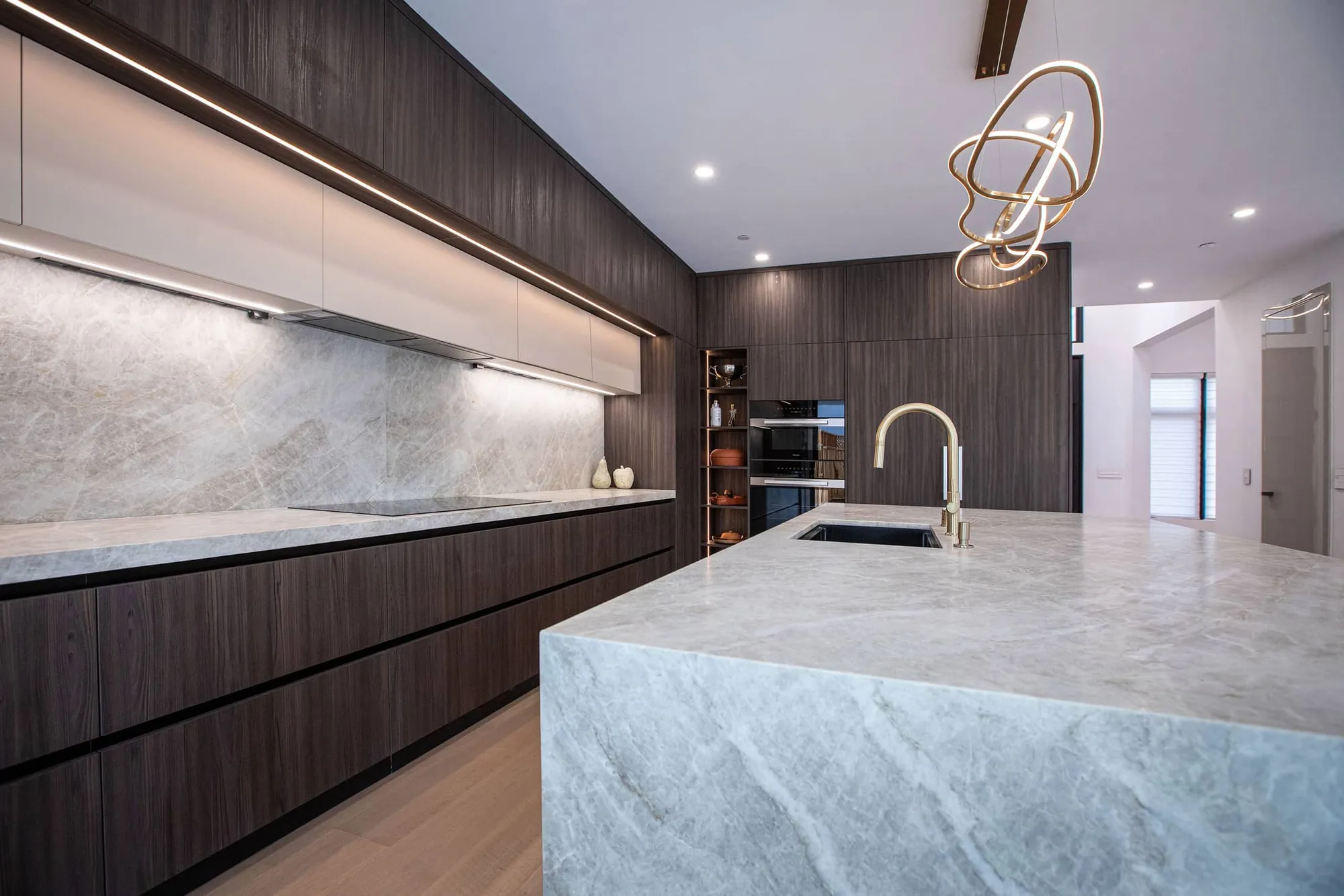 Marble island and custom cabinetry detail in the luxury kitchen