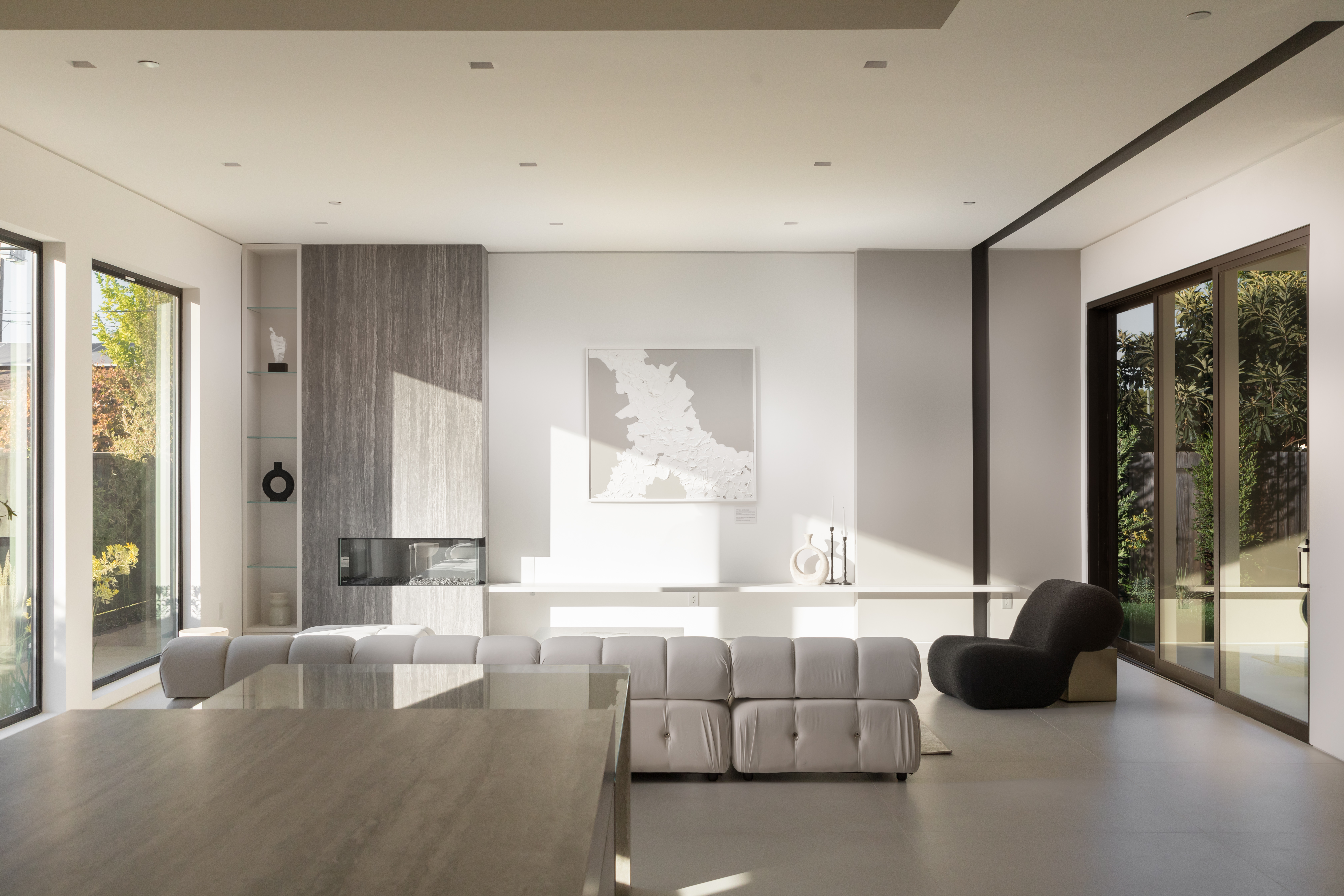 Sunlit modern living room with custom fireplace representing the final white-glove handover of a Bay Area custom home build.