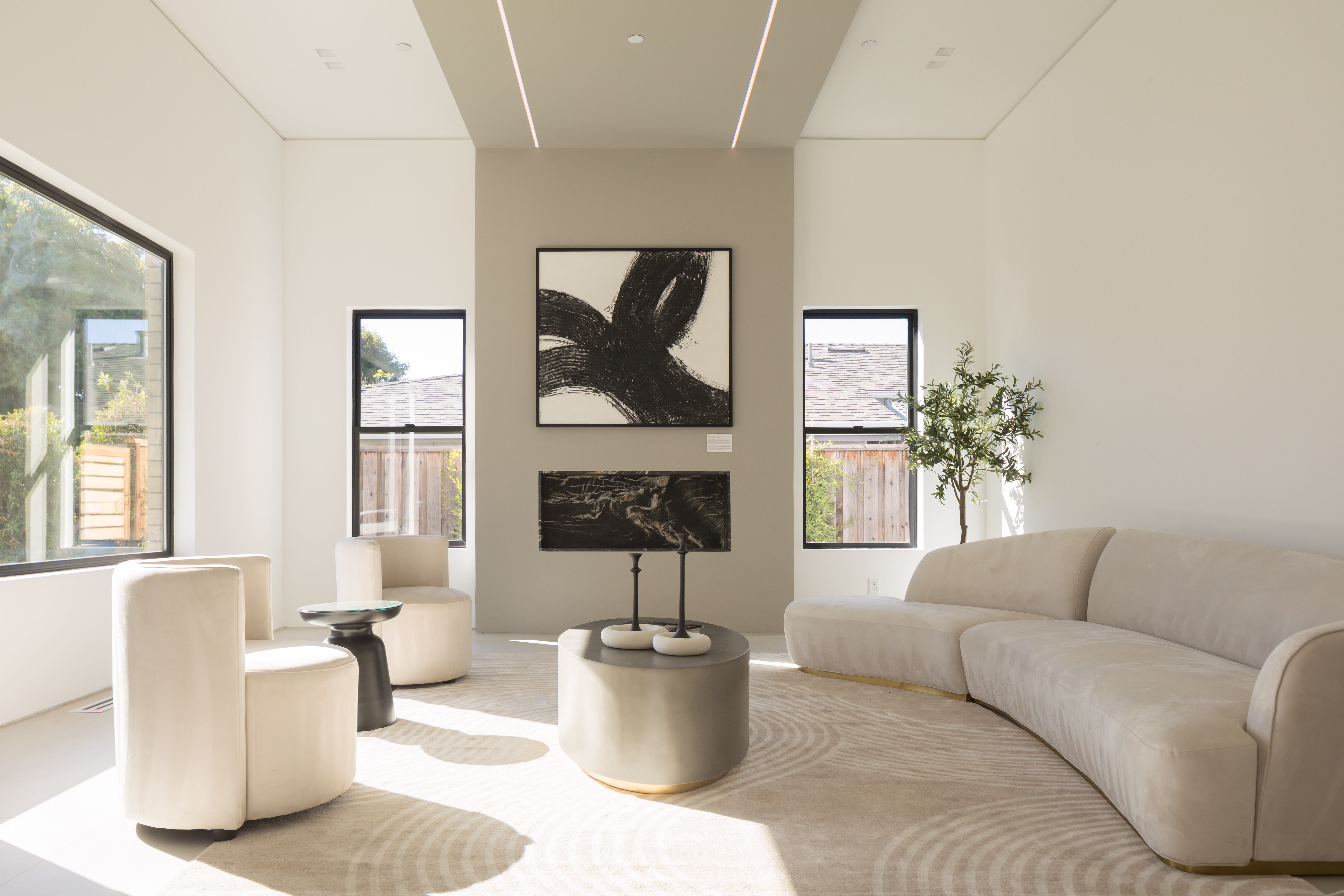 High-ceiling modern living area in Cupertino with custom architectural detailing and premium finishes by Ritz Builders.